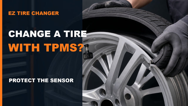 Technician carefully positioning a tire bead around an alloy wheel with a valve-stem TPMS sensor visible inside the rim